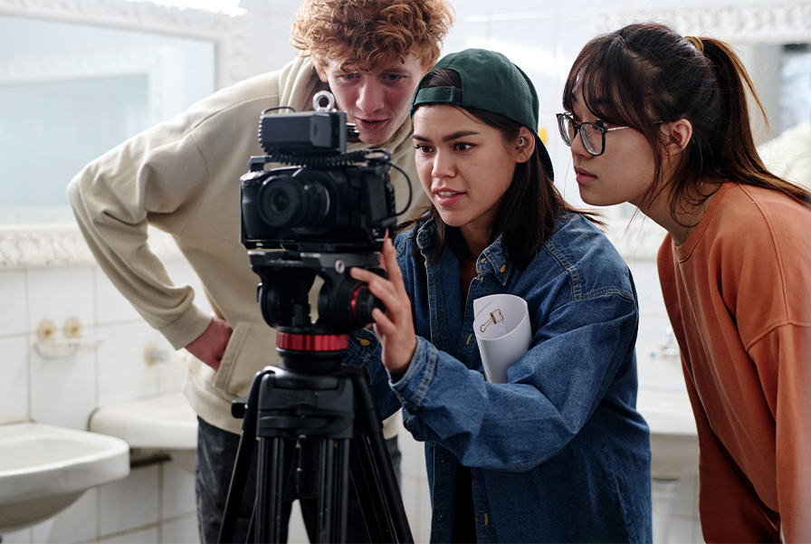 A group of students collaborate on a film production project for a creative media course.