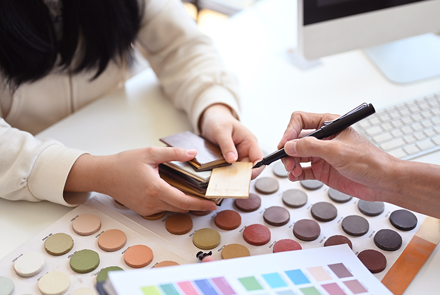 Close-up of interior designers selecting wood and colour samples.